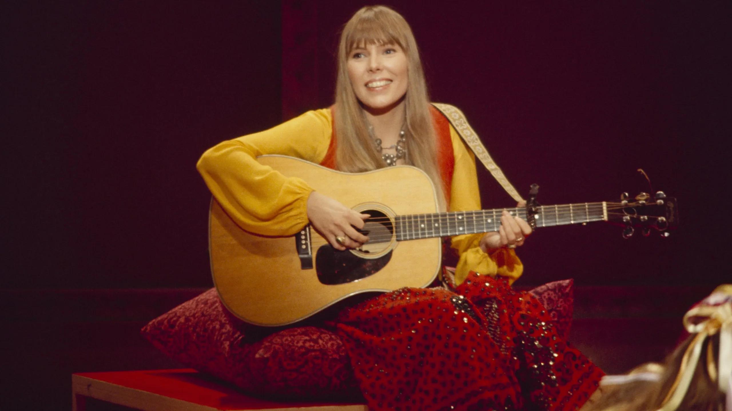 How was Joni Mitchell introduced to singing